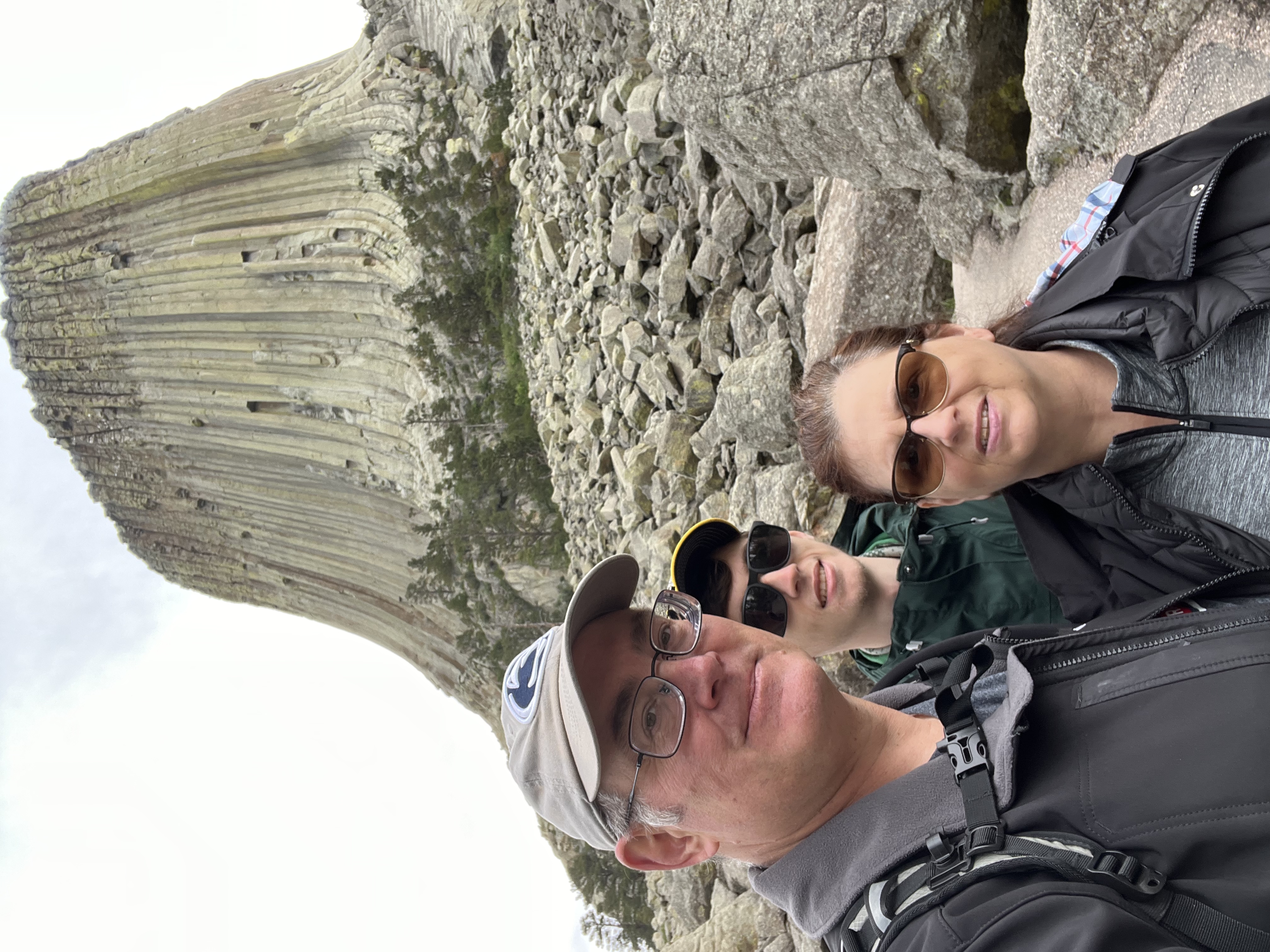 Devils Tower rising above the Wyoming plain, its vertical columns visible on the near face.